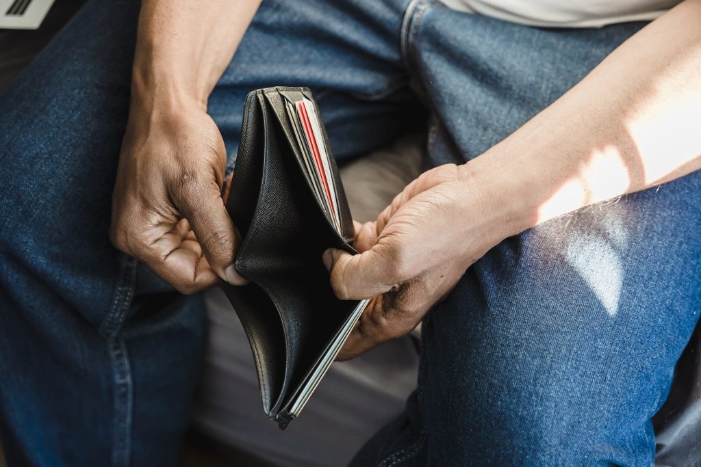 Man Looking at an Empty Wallet